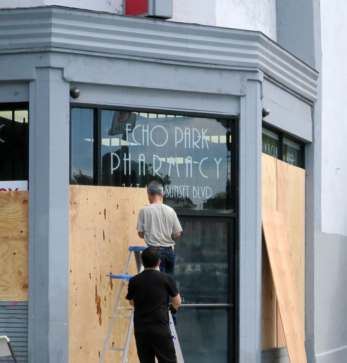 Plywood & Panic: Business owners rush to board up windows