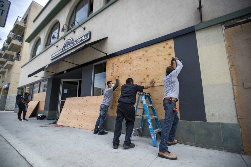 ‘Everything already stolen!’ With plywood and paint, businesses seek mercy, express solidarity