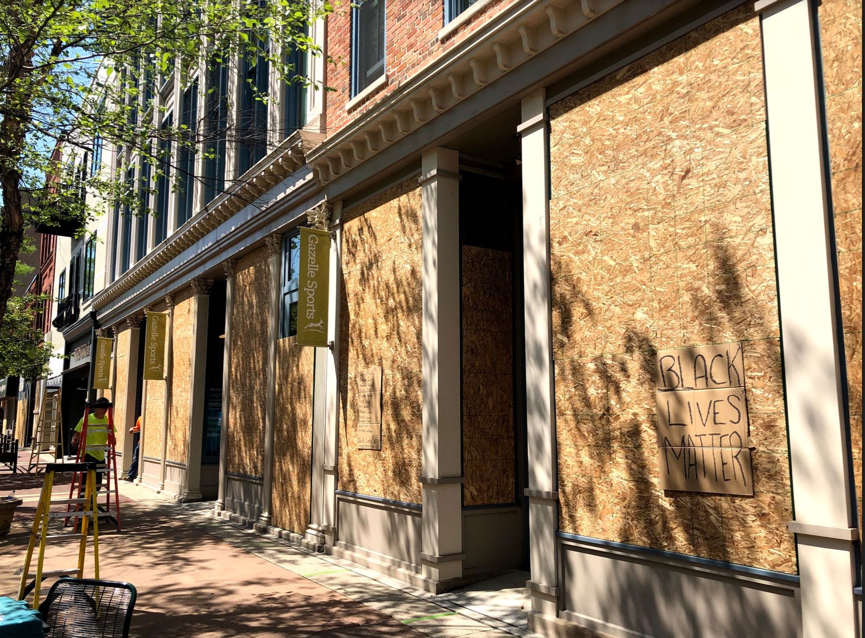 In downtown Kalamazoo, store owners erect plywood and brace for damage