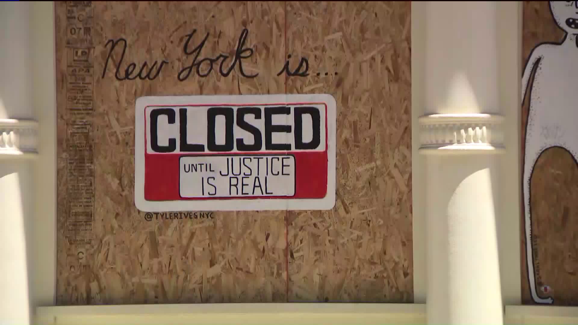 As Manhattan shops get boarded up, the plywood sends a message