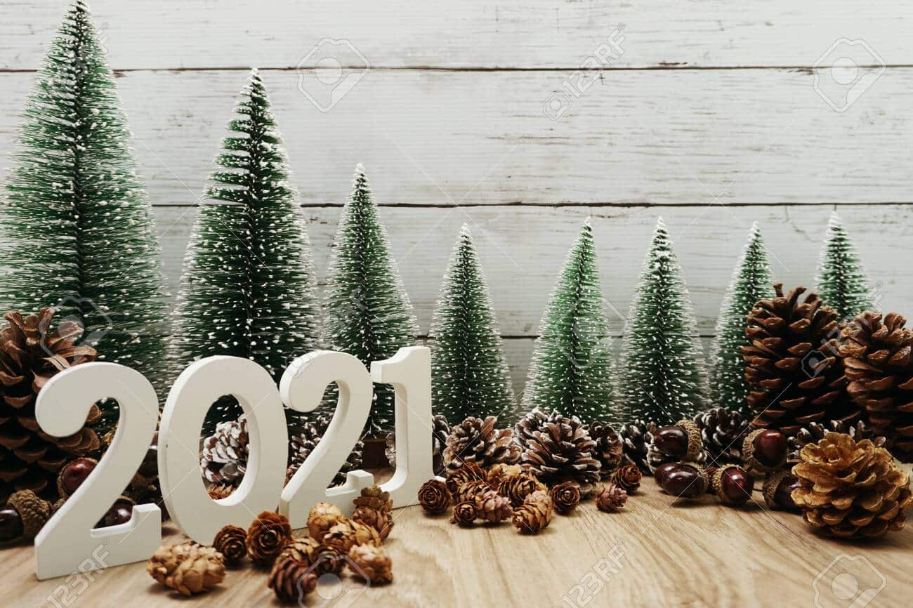 140019371 happy new year 2021 festive background with christmas tree and pine cone decoration on wooden backgr