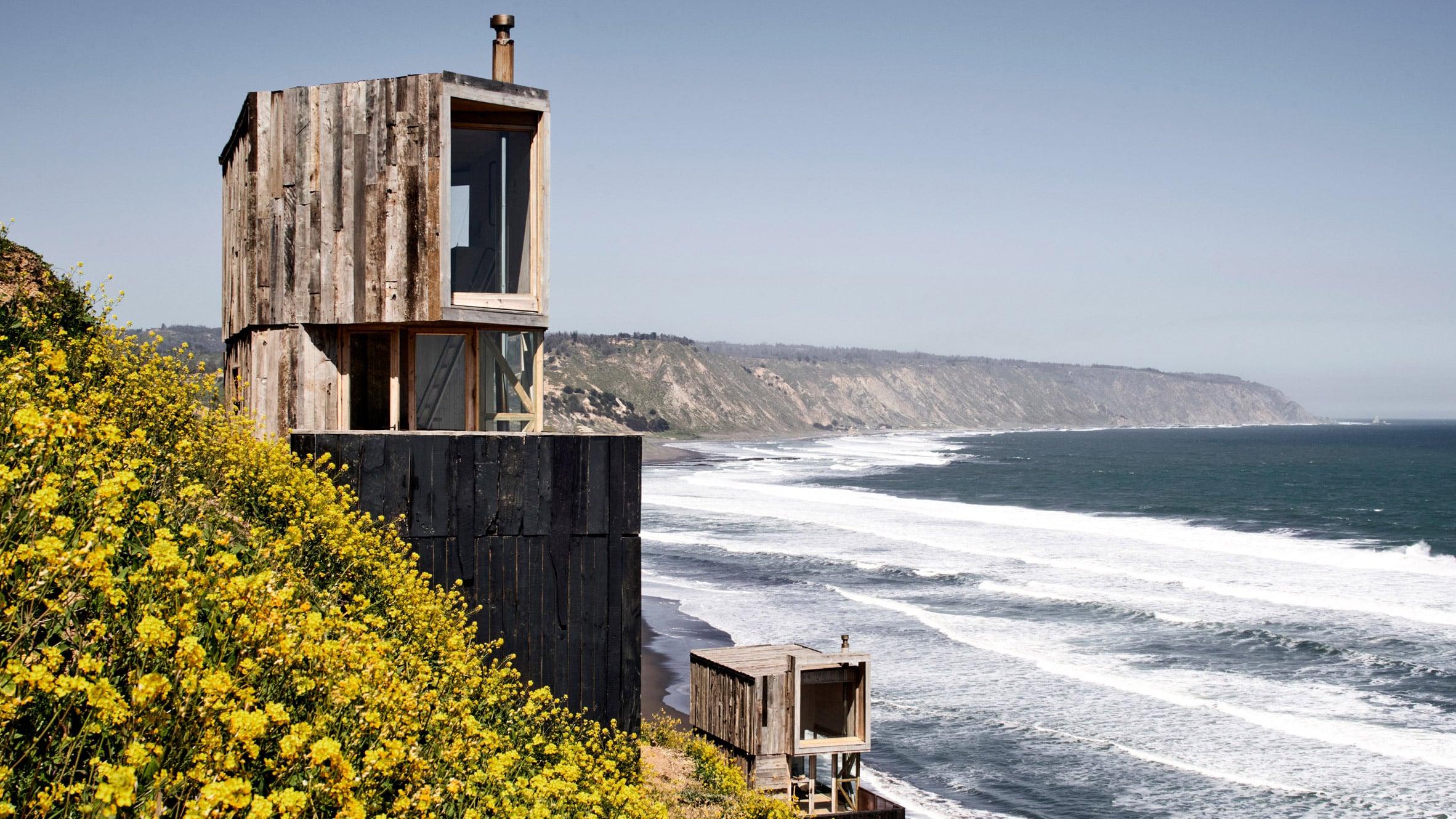 Croxatto and Opazo Architects perches timber-clad cabins on a coastal hillside in Chile